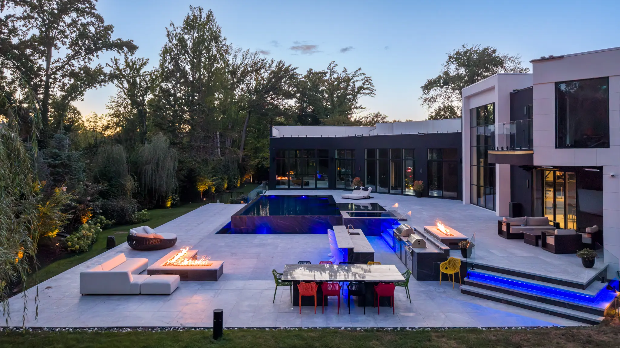 Kings Point pool and outdoor living terrace at dusk
